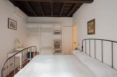 a bedroom with a bed and shelves in it at Elegante rifugio in centro storico Roma tra Piazza del Popolo e Piazza di Spagna in Rome