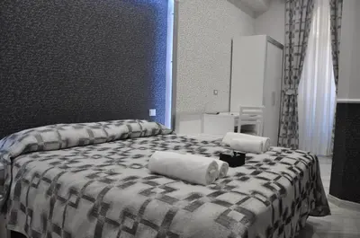 a large bed with two pillows on top of it at Il Corso Suite in Rome