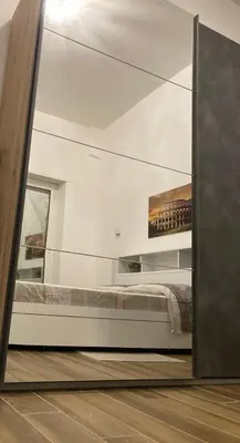 a mirror reflection of a bed in a bedroom at Welcome to Rome Baldo in Rome