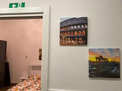 a bedroom with two paintings on the wall at Welcome to Rome Baldo in Rome