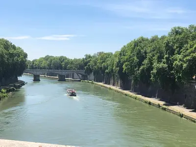 a boat in a river with a bridge in the background at Welcome to Rome Baldo in Rome