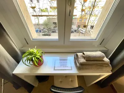 a small table with a window and a plant on it at Casa Vasari in Rome