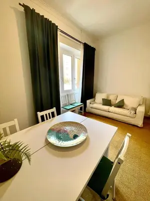 a living room with a table and a couch at Casa Vasari in Rome