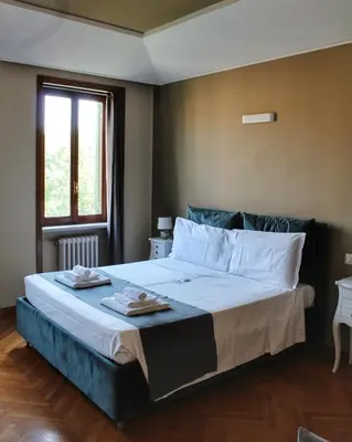 a bedroom with a large bed with two towels on it at Relais La Fornarina 2 in Rome
