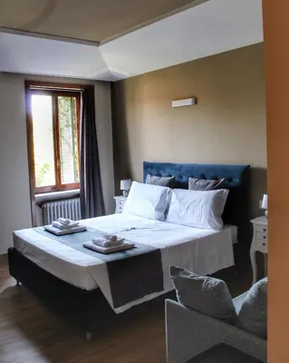 a bedroom with a large bed and a window at Relais La Fornarina 2 in Rome