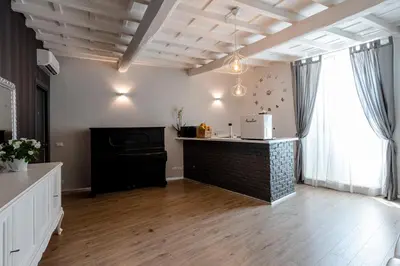 a living room with a brick counter and a window at Relais La Fornarina 2 in Rome