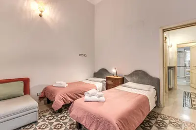 a room with two beds and a couch at Montebello Apartments79 in Rome
