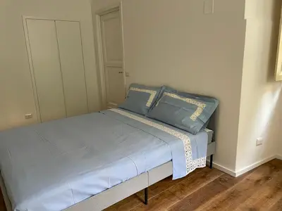 a bed with blue pillows in a bedroom at Deromatality Vaticano Piazza di Spagna Colosseo in Rome