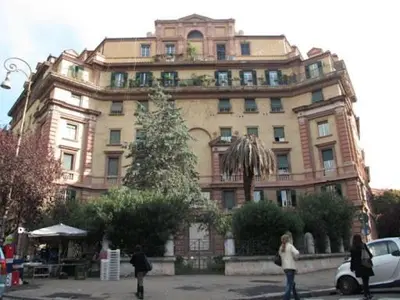 a large building with a christmas tree in front of it at Deromatality Vaticano Piazza di Spagna Colosseo in Rome