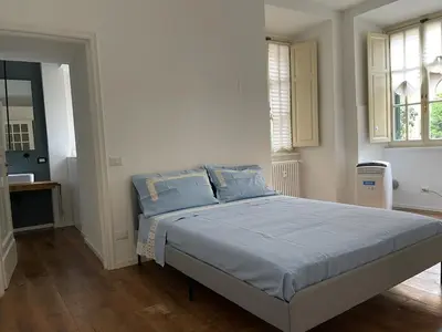 a bedroom with a large bed with blue sheets at Deromatality Vaticano Piazza di Spagna Colosseo in Rome