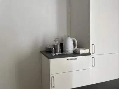 a kitchen with white cabinets and a blender on a counter at Deromatality Vaticano Piazza di Spagna Colosseo in Rome