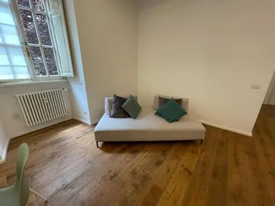 a white couch with four pillows in a room at Deromatality Vaticano Piazza di Spagna Colosseo in Rome