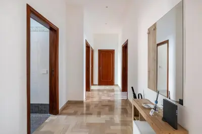an empty corridor of an apartment building with plants on balconies at Casa amoR in Trastevere in Rome