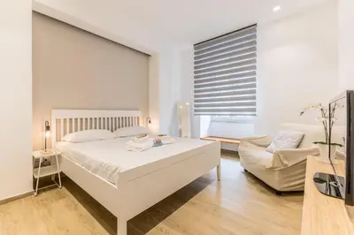 a white bedroom with a bed and a couch at Principe Umberto Suite - Stazione Termini in Rome