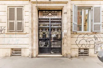 a building with a door with graffiti on it at Principe Umberto Suite - Stazione Termini in Rome