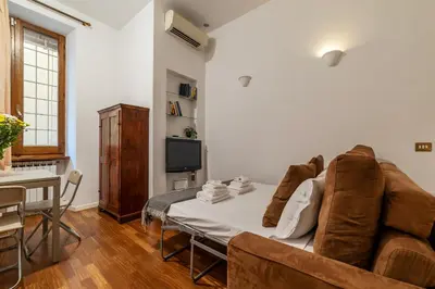 a living room with a couch and a table at A stone’s throw from the Colosseum! in Rome