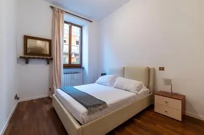 a small bedroom with a bed and a window at A stone’s throw from the Colosseum! in Rome