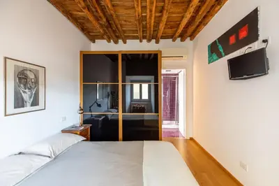 a bedroom with a bed and a tv at iFlat Homey in Campo de'Fiori in Rome