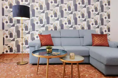 a living room with a blue couch and a table at Comfy apartment next to Vatican City in Rome