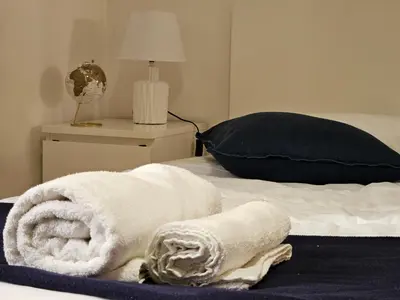 a pile of towels sitting on top of a bed at Domus Ottaviano - Vaticano in Rome