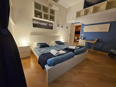a bedroom with a large bed with blue sheets at Domus Ottaviano - Vaticano in Rome