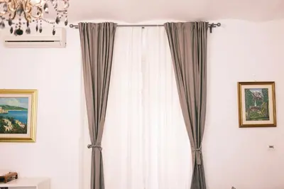 a room with curtains and a chandelier at Termini Rita House in Rome