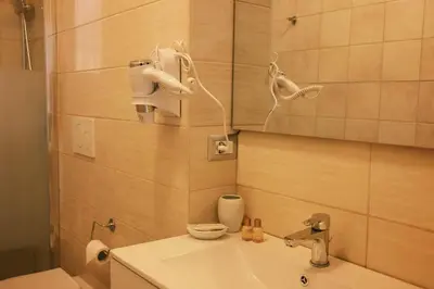 a bathroom with a sink and a mirror at Termini Rita House in Rome