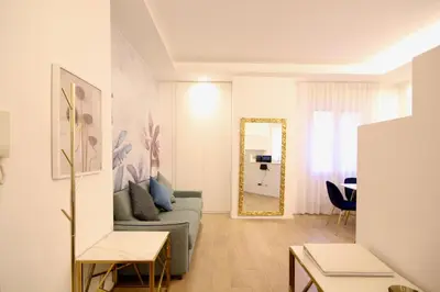 a living room with a couch and a mirror at HC - Live Doria Luxury Apt by the Vatican in Rome