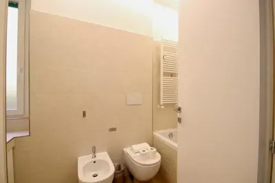 a bathroom with a toilet and a bidet at HC - Live Doria Luxury Apt by the Vatican in Rome