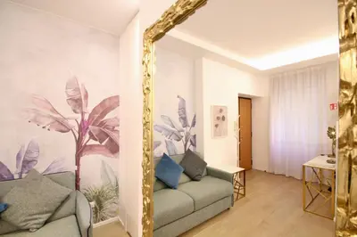 a living room with a couch and a mirror at HC - Live Doria Luxury Apt by the Vatican in Rome