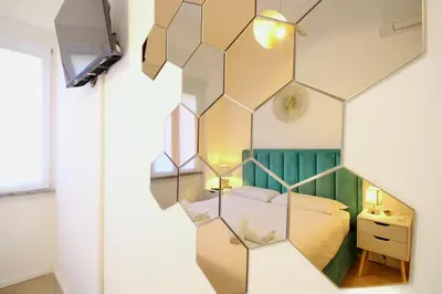 a bedroom with a mirror in the corner of a room at HC - Live Doria Luxury Apt by the Vatican in Rome