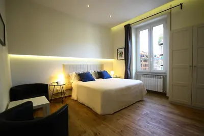 a bedroom with a bed and a large window at Passenger Vatican Relais in Rome