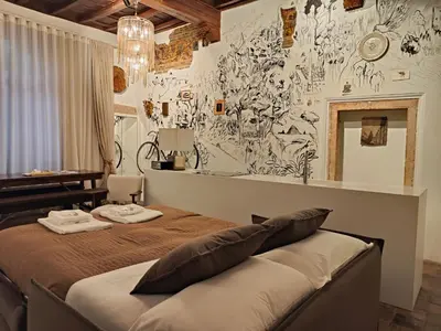 a bedroom with a bed and a wall covered in graffiti at The Eclectic Home of Collector - Navona Square in Rome
