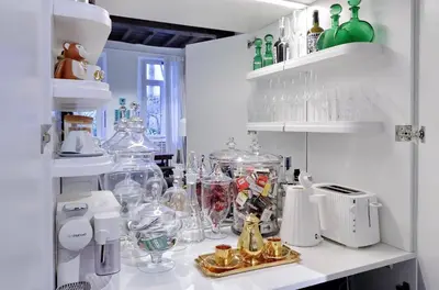 a kitchen with many glass vases on a counter at The Eclectic Home of Collector - Navona Square in Rome