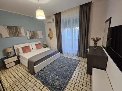 a bedroom with a bed and a large window at Terrace Penthouse - meospiti Penthouse in Rome