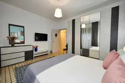 a bedroom with a large bed and a television at Terrace Penthouse - meospiti Penthouse in Rome