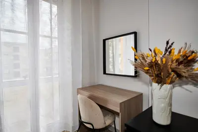 a vase of flowers sitting on a table next to a window at Terrace Penthouse - meospiti Penthouse in Rome