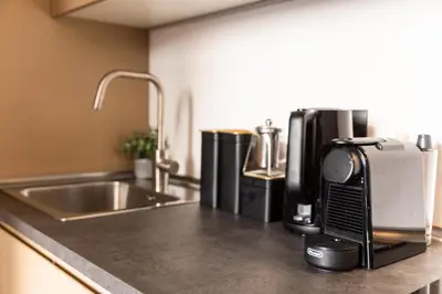 a kitchen counter with a coffee maker and a sink at Testaccio Boutique Apartment in Rome in Rome