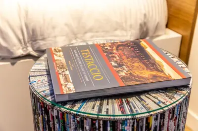 two books sitting on top of a drum of cds at Testaccio Boutique Apartment in Rome in Rome