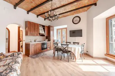 a kitchen and dining room with a table and chairs at Dimora di Trastevere in Rome