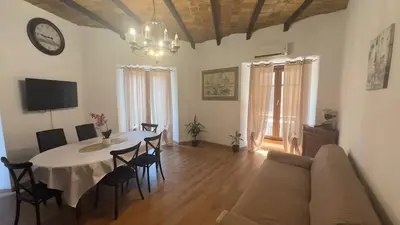 a living room with a table and a couch at Dimora di Trastevere in Rome