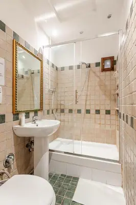 a bathroom with a sink and a toilet and a tub at Dimora di Trastevere in Rome
