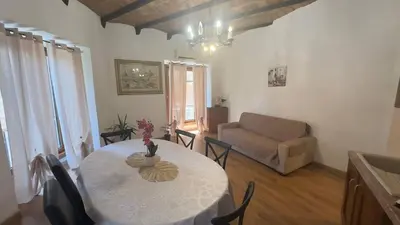 a living room with a table and a couch at Dimora di Trastevere in Rome