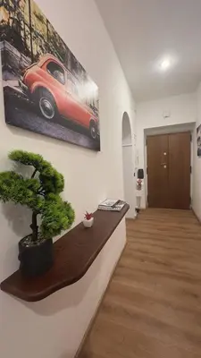 a room with a picture of a red car on the wall at Dimora di Trastevere in Rome