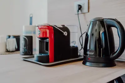 a red and black toaster sitting on a counter at Domus Æterna - Re di Roma in Rome