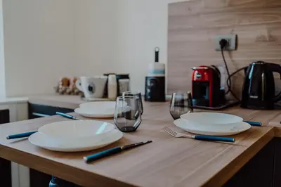 a wooden table with plates and glasses on it at Domus Æterna - Re di Roma in Rome
