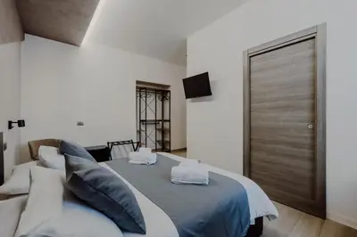 a bedroom with a bed and a sliding door at Domus Æterna - Re di Roma in Rome