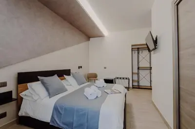 a bedroom with a bed with two towels on it at Domus Æterna - Re di Roma in Rome