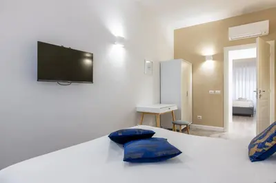 a bedroom with a bed with two blue pillows at Vatican 2BR apartment in Roma in Rome