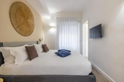a bedroom with a white bed with pillows on it at Vatican 2BR apartment in Roma in Rome
